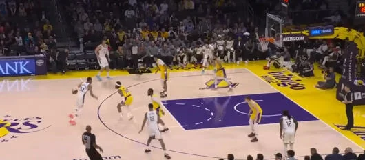 Basketball offensive play with strong defense from the opposing team