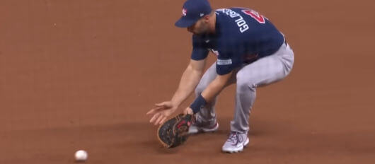 A baseball player attempting to catch a ball during a game, reflecting key moments for betting